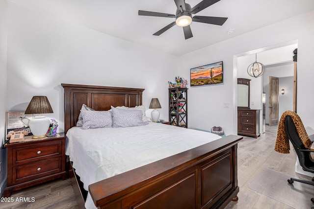 bedroom with light wood finished floors and a ceiling fan