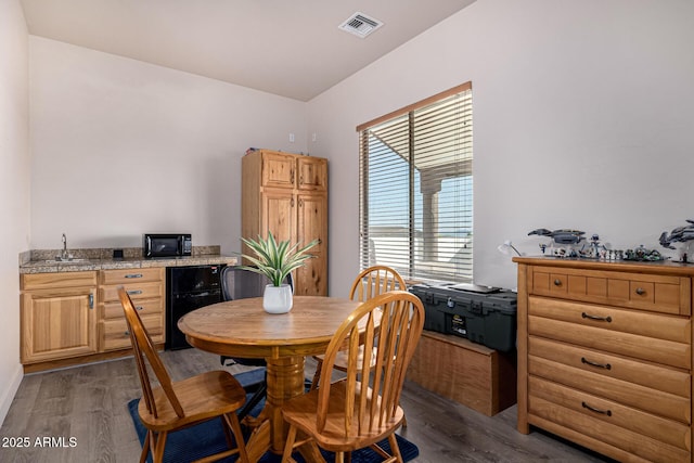 dining space featuring dark wood-style flooring and visible vents