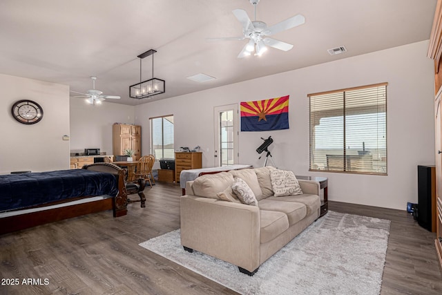 bedroom featuring ceiling fan, visible vents, baseboards, and dark wood finished floors