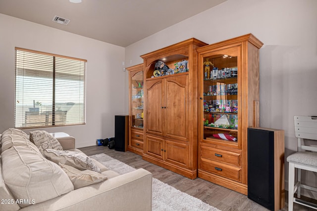 living area featuring visible vents and light wood-style flooring