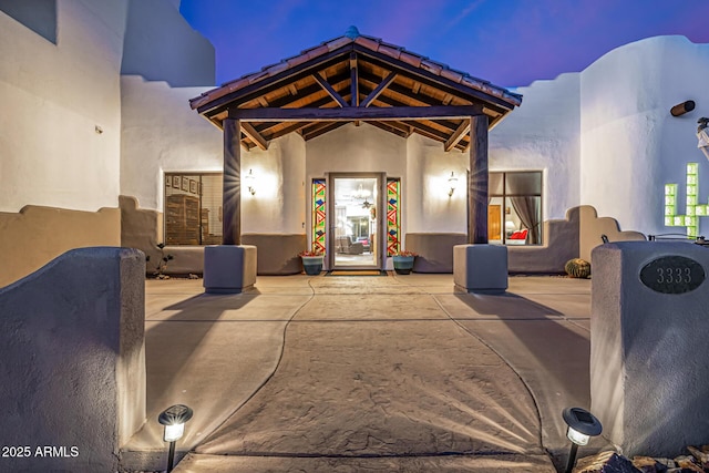 exterior space with a patio area and stucco siding