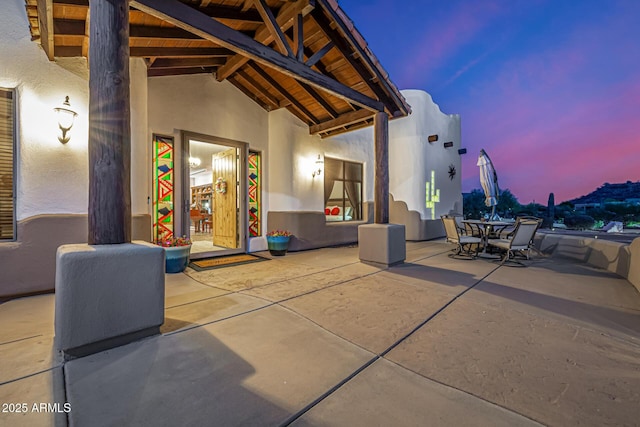 patio terrace at dusk featuring outdoor dining area