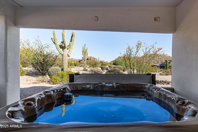view of pool with a hot tub