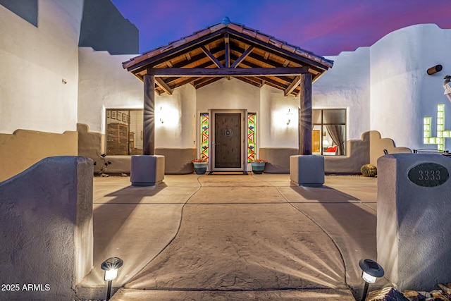 view of front of house featuring a patio area and stucco siding