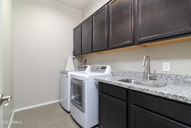 laundry room with cabinets, separate washer and dryer, and sink