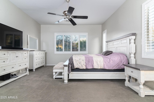 bedroom featuring ceiling fan and dark colored carpet