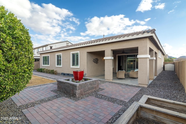 back of property with a patio area and ceiling fan