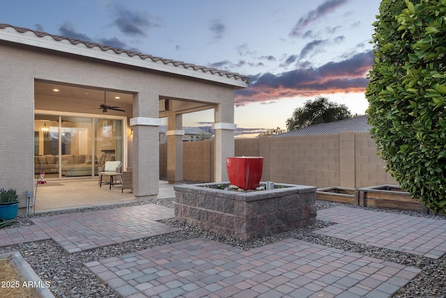 patio terrace at dusk with ceiling fan