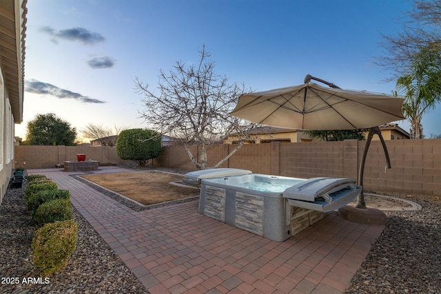 patio terrace at dusk with a hot tub