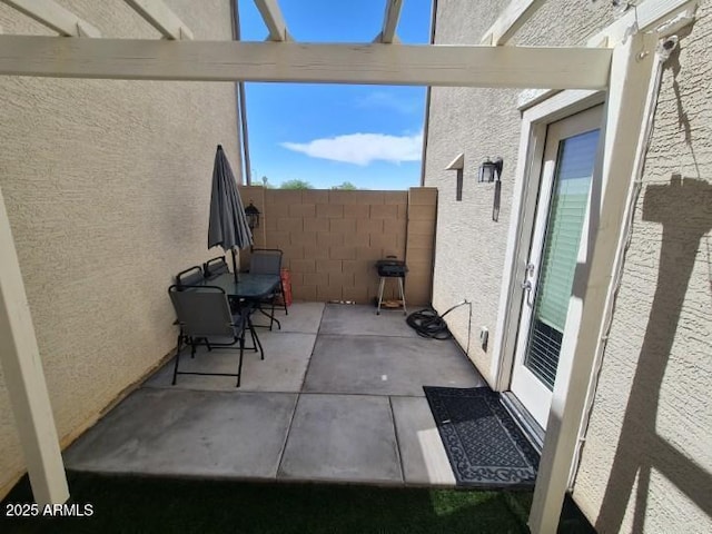 view of patio featuring fence