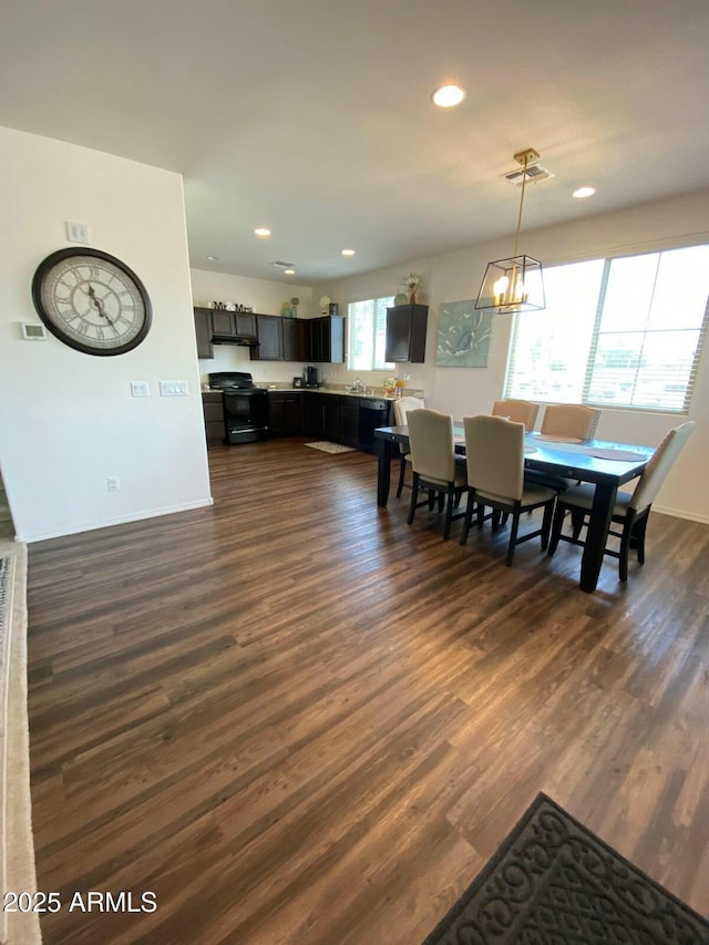 dining space featuring visible vents, baseboards, dark wood finished floors, recessed lighting, and an inviting chandelier