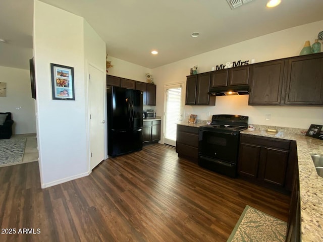 kitchen featuring dark brown cabinetry, black appliances, under cabinet range hood, and dark wood-style flooring