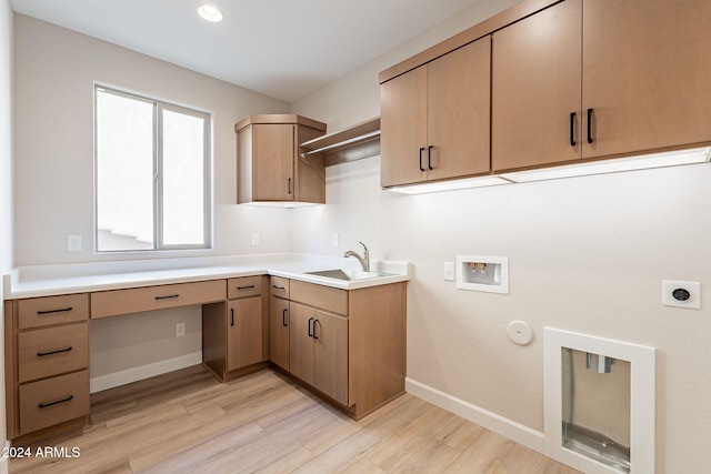 laundry room with sink, cabinets, electric dryer hookup, light hardwood / wood-style flooring, and hookup for a washing machine