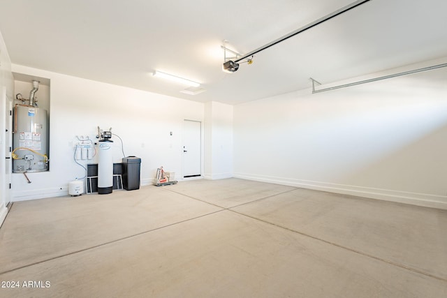 garage with water heater and a garage door opener