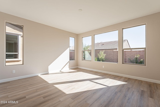 unfurnished room with light hardwood / wood-style flooring