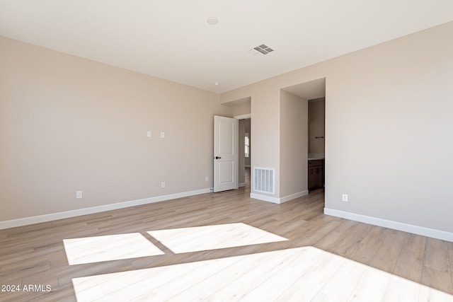 empty room with light hardwood / wood-style flooring