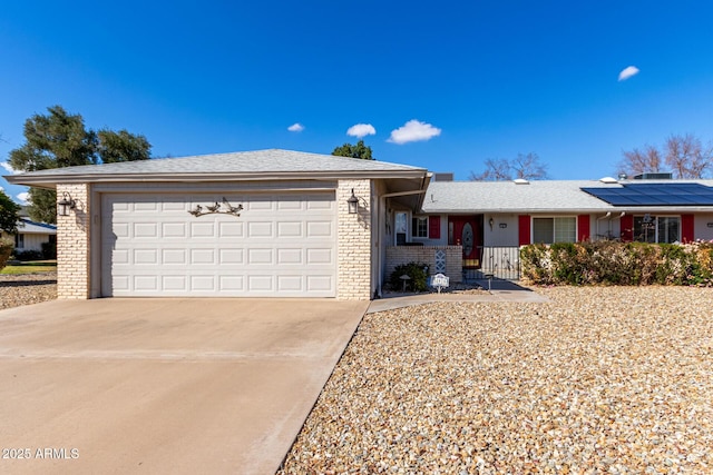 view of front of property featuring a garage and solar panels