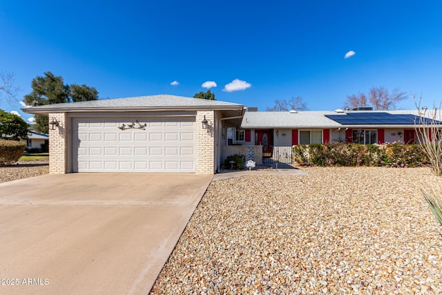 view of front of house featuring a garage and solar panels