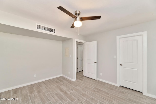 unfurnished bedroom featuring visible vents, baseboards, light wood finished floors, and ceiling fan