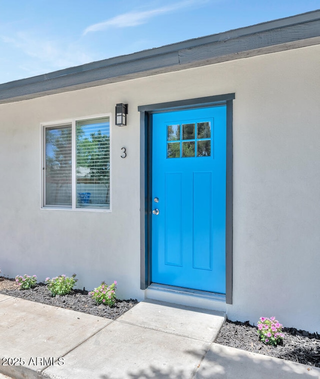 doorway to property with stucco siding