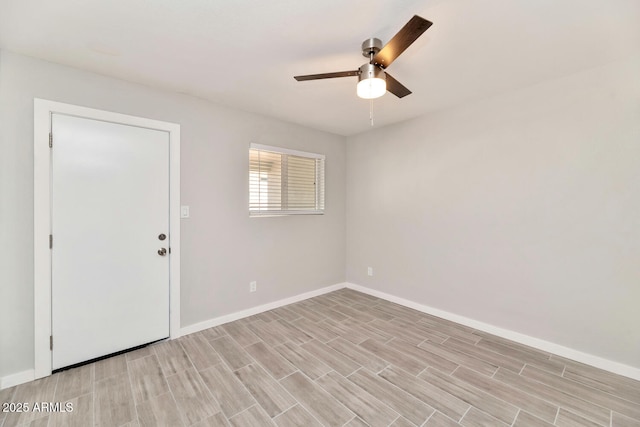 empty room with light wood-type flooring, baseboards, and a ceiling fan