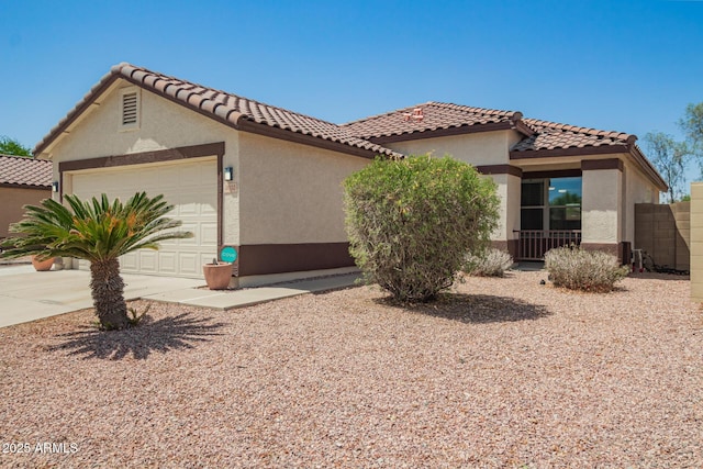 3032 W Red Fox Rd, Phoenix, AZ 85083 - mediterranean / spanish-style home with an attached garage, stucco siding, concrete driveway, a tile roof, and fence