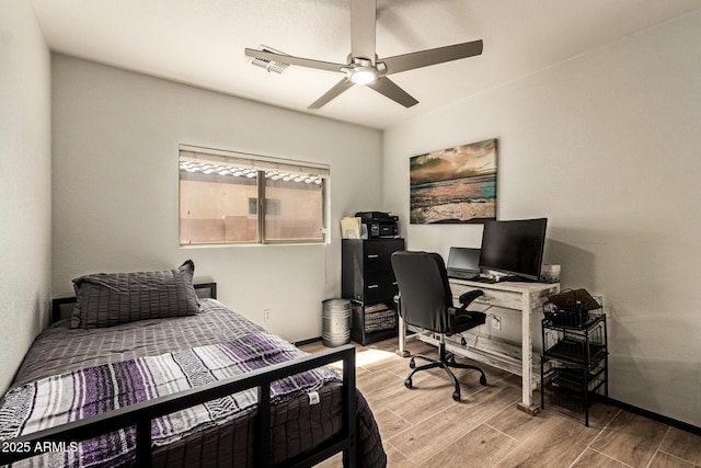 3032 W Red Fox Rd, Phoenix, AZ 85083 - bedroom with wood finished floors, a desk, a ceiling fan, and baseboards