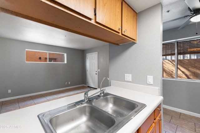 kitchen with ceiling fan, sink, and light tile patterned floors