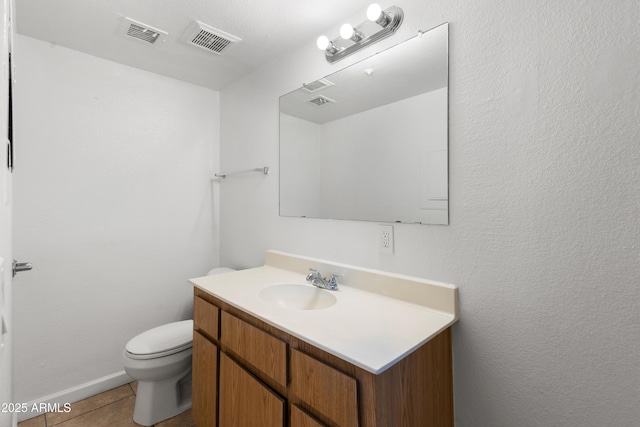 bathroom with toilet, tile patterned flooring, and vanity