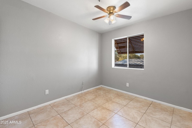 unfurnished room with ceiling fan and light tile patterned flooring