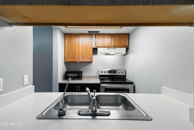 kitchen featuring stainless steel electric range and sink