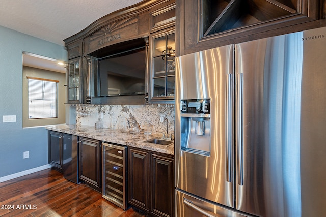 kitchen featuring wine cooler, sink, tasteful backsplash, stainless steel refrigerator with ice dispenser, and dark wood-type flooring