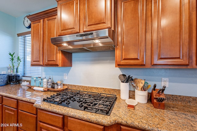 kitchen featuring light stone countertops and black gas cooktop