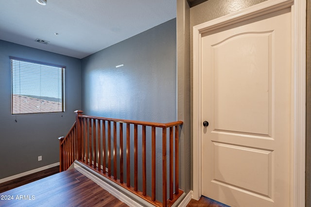 stairway featuring wood-type flooring