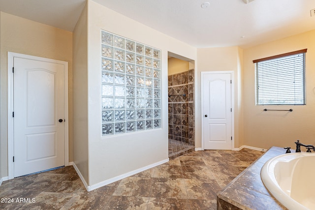 bathroom featuring shower with separate bathtub and sink