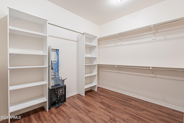 spacious closet featuring dark hardwood / wood-style floors