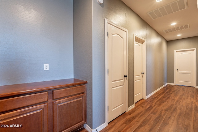 hallway with dark hardwood / wood-style flooring