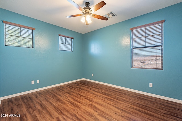 spare room featuring hardwood / wood-style flooring and ceiling fan