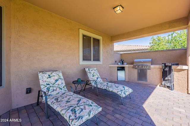 view of patio / terrace with an outdoor kitchen and a grill