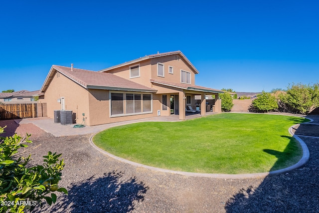 rear view of property featuring a patio area and a yard