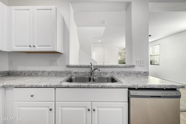 kitchen with dishwasher, kitchen peninsula, white cabinetry, and sink