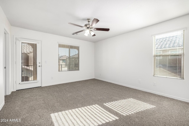 carpeted spare room with ceiling fan