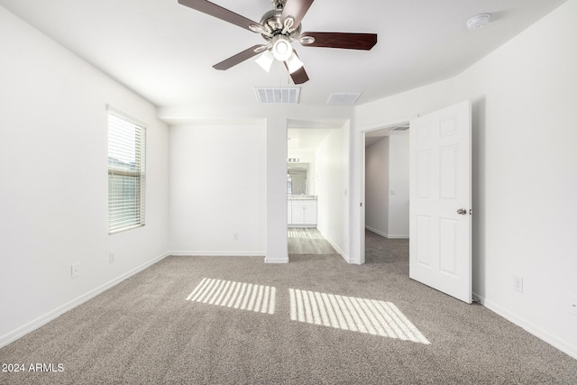 spare room with ceiling fan and light colored carpet