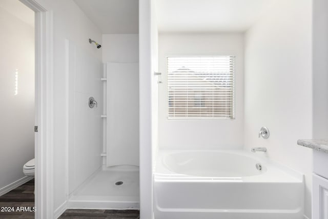 full bathroom featuring hardwood / wood-style floors, vanity, toilet, and separate shower and tub