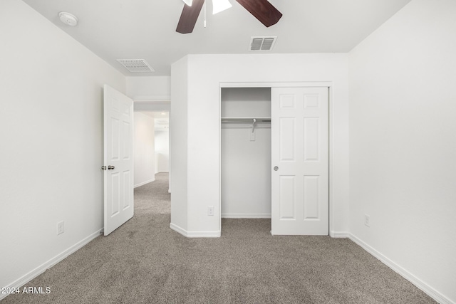 unfurnished bedroom featuring ceiling fan, a closet, and carpet