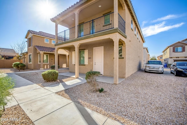 view of front of house with covered porch and a balcony