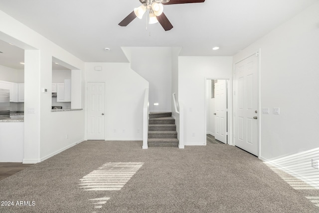 unfurnished living room featuring carpet and ceiling fan