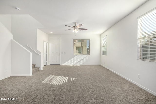 carpeted empty room featuring ceiling fan