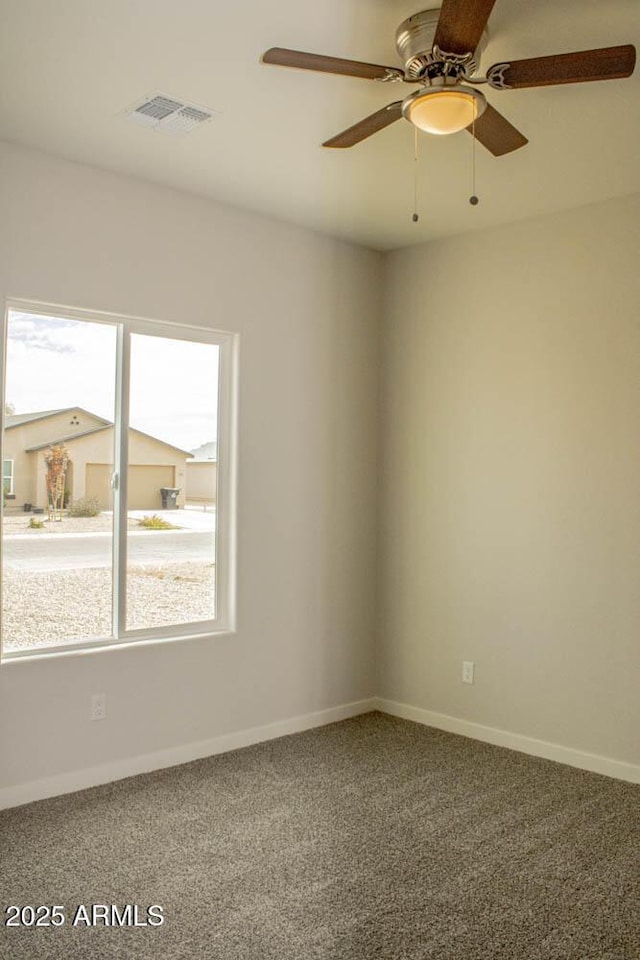 spare room featuring carpet, plenty of natural light, and ceiling fan