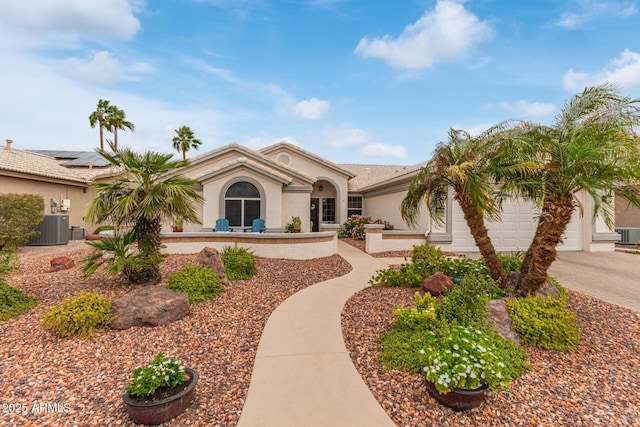 view of front of property with stucco siding, decorative driveway, cooling unit, and an attached garage